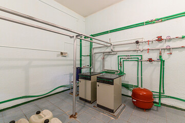 interior apartment room boiler room. heating system, pipes and appliances