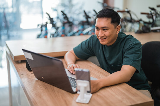 Handsome Man Business Owner Uses Laptop Computer While Working In Store