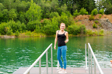Fototapeta na wymiar Young woman in the Kvetnica lake in the region of Tatra mountains