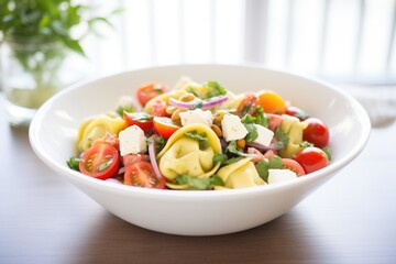 tortellini salad with olives, tomatoes, and feta cheese