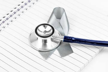 Cancer awareness concept with ribbon on doctor table.