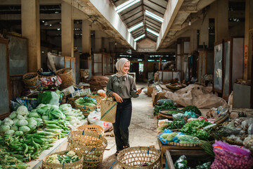 asian customer strolling around farmer market searching for vegetables