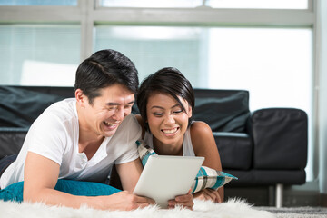 happy Asian woman using Digital Tablet at home