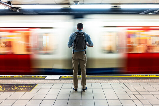 Businessman waiting for train on subway platform