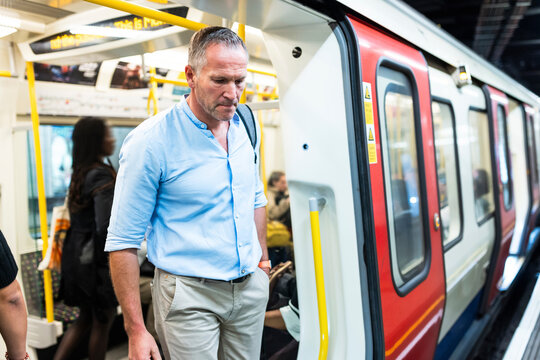 Businessman disembarking from train at subway station