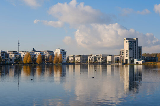 Germany, North Rhine Westphalia, Dortmund, Lake Phoenix with city buildings in background