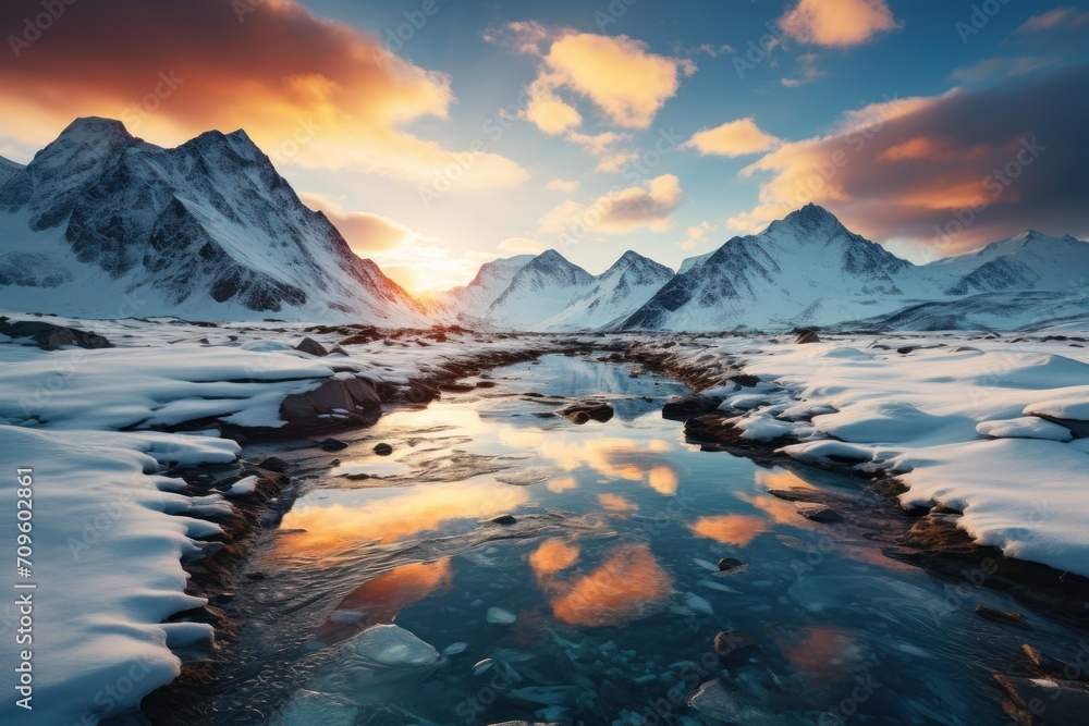 Poster the sun is setting over a mountain range with a stream of water in the foreground and snow covered r