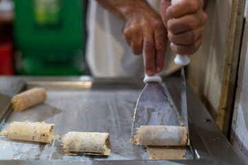 Crafting Rolled Ice Cream Delight on a Hot Metal Plate
