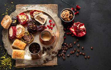 Hot tasty coffee with various pieces of turkish delight desets on a dark background. Traditional arabian food