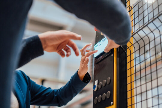 Engineers operating control panel in industry