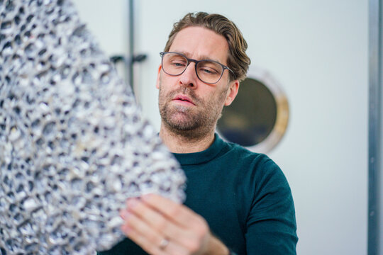 Businessman analyzing foam in workshop