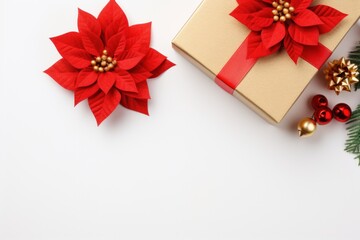  a gift box with a red ribbon and two poinsettis on top of it next to a christmas tree.