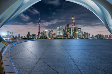 Empty square floor and modern city building landscape at night in Shanghai