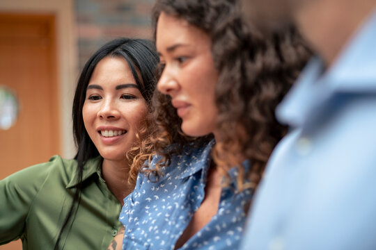 Multiracial colleagues in office corridor