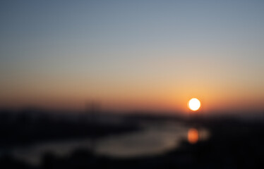 Blurred city view during sunset.