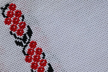 black red Ukrainian embroidery on white canvas, a fragment of a decorated wedding towel, flowers embroidered on white canvas 