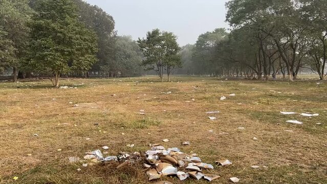 Maidan covered with plastic wastes on a winter foggy morning in Kolkata, India after CPM rally in Brigade ground 2024.