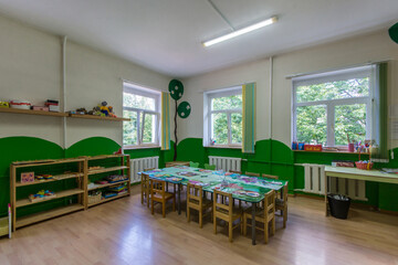 A cozy room for children's creativity in kindergarten with a large table.