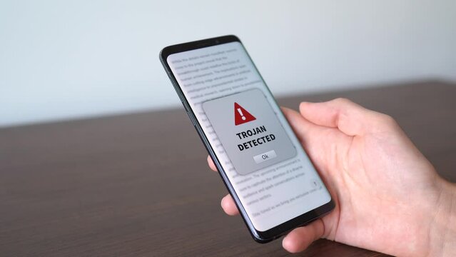 Trojan alert notification appearing on the phone while in use. Antivirus concept in action.