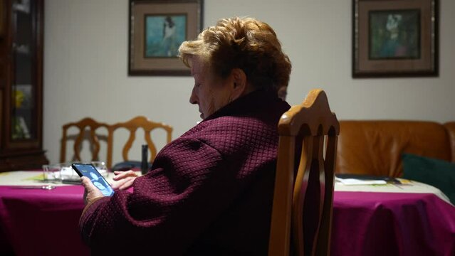 Granny talking with someone while screen scrolling on the smartphone