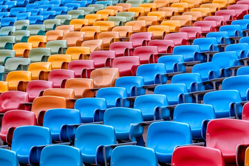 Obraz premium Colorful plastic chairs in a stadium. Background for design.