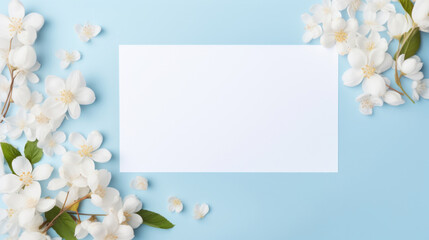 A blank card surrounded by delicate white cherry blossoms on a blue background, perfect for a heartfelt message or invitation.