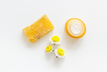 Chamomile flowers and herbs with face cream and organic soap