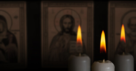 Fototapeta na wymiar candles on the black background with religion icon close up