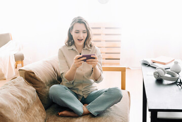 Surprised millennial reaction. Happy woman with open mouth looking at phone, reading message, playing mobile game. Expressive emotion, technology entertainment and modern lifestyle concept.