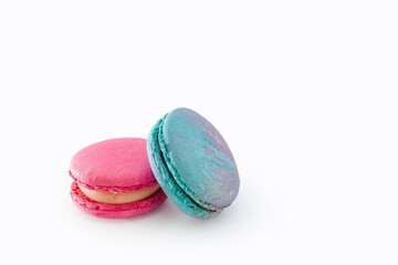 Tasty colorful macarons isolated on white background. Sweet macaroons dessert. Two multi-colored blue and pink macaroons. French pastry, almond cookies from egg whites.