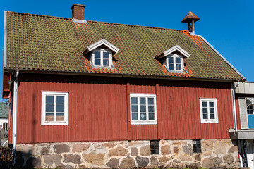 Traditional old red vintage wooden house in Sweden. Scandinavian sightseeing. 