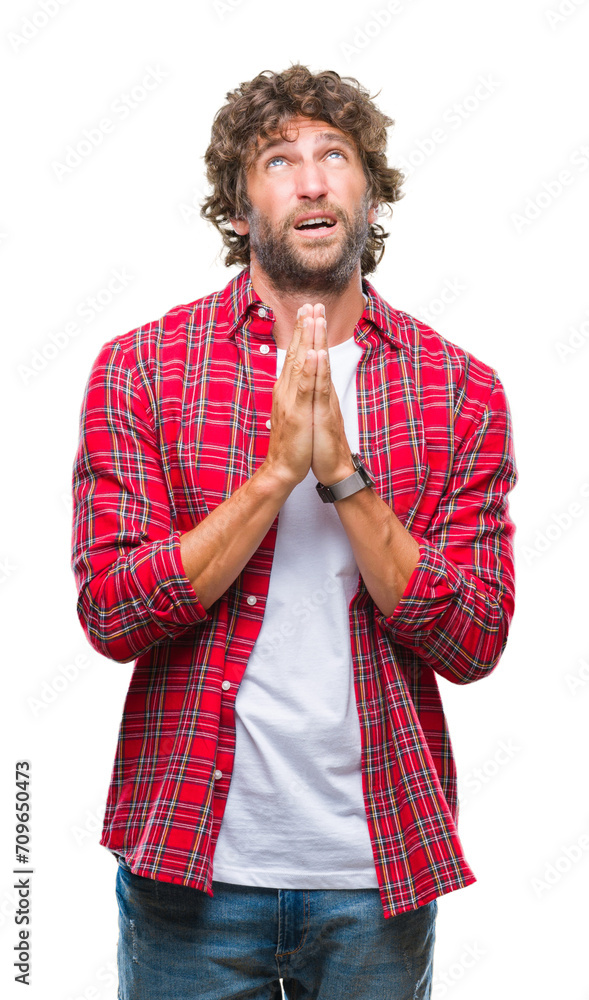 Sticker handsome hispanic model man over isolated background begging and praying with hands together with ho