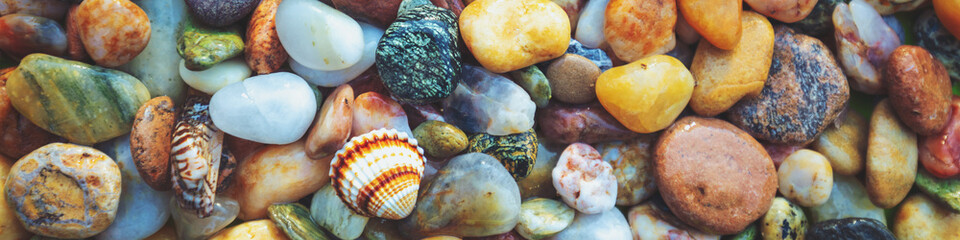 Abstract nature pebbles background. Colorful pebbles texture. Stone background. Sea pebble beach. Beautiful nature. Horizontal banner - obrazy, fototapety, plakaty