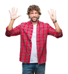 Handsome hispanic model man over isolated background showing and pointing up with fingers number...
