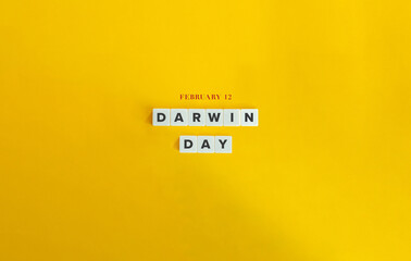 Darwin Day Banner. February 12. Block Letter Tiles on Yellow Background. Minimalist Aesthetics.