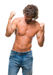 Fototapeta premium Handsome hispanic model man sexy and shirtless over isolated background very happy and excited doing winner gesture with arms raised, smiling and screaming for success. Celebration concept.