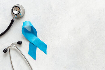Blue ribbon symbol of prostate or colon cancer awareness concept