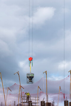 Bricklayer working with loading a construction crane