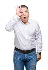 Fototapeta premium Middle age arab elegant man over isolated background doing ok gesture shocked with surprised face, eye looking through fingers. Unbelieving expression.