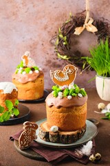 Easter cake with gingerbread decor and sponge moss on a brown concrete background. Easter dishes, Easter concept.