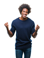 Afro american man over isolated background celebrating surprised and amazed for success with arms...