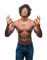 Afro american shirtless man showing nude body over isolated background relax and smiling with eyes closed doing meditation gesture with fingers. Yoga concept.