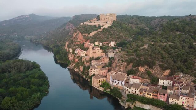 Miravet Castle and riverside town at Ebro River shore. Tarragona.