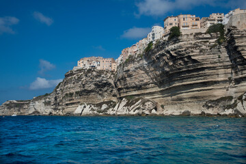 Fototapeta na wymiar Bonifacio sits on white lime stone cliffs on the southern tip of the island of Corsica, in the French department of Corse-du-Sud.