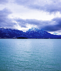 Forggensee panoramic view with the German Alps mountains during a cloudy winter afternoon
