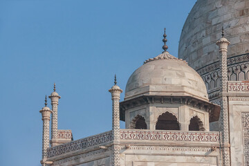 Main and smaller marble domes and decorative spires of Taj Mahal mausoleum. Close up photo. Agra,...