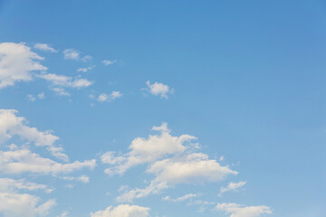 Clear blue sky with small fluffy clouds. Atmosphere background or wallpaper