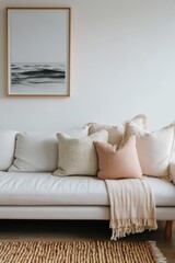Minimalistic modern living room area in gray and beige colors with a sofa, cushions and picture on the wall, copy space