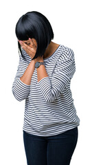 Beautiful young african american woman wearing stripes sweater over isolated background with sad expression covering face with hands while crying. Depression concept.