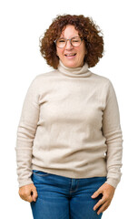 Beautiful middle ager senior woman wearing turtleneck sweater and glasses over isolated background winking looking at the camera with sexy expression, cheerful and happy face.